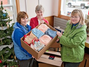 BRIAN THOMPSON, The Expositor

Katherine Ritchie (left), Janice Wright and Rita Mork show some of the more than 500 clothing items donated by Scotland residents for the children of the Attawapiskat in northern Ontario.