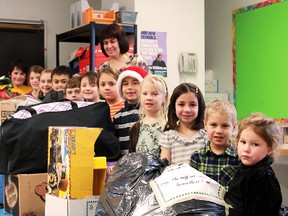 A representative from each of the classes at Sacred Heart School stand proudly next to the boxes and bags filled with donated goods, ready to be given over to the North Eastern Ontario Family and Children's Services on Tuesday. Each class adopted a family and tried its best to make their wish lists come true. Standing in the back is Sylvie Guévremont, The students from left are Connor Lahaie, Kennedy Decario, Kaili Barker, Nathan Dutkiewicz, Harry Clark, Noah Blair, Emilia Oliver, Dayton Cook, Maycee Vierimma, Ava Guillemette, Nicholas Earbuto and Adison Dubeau.