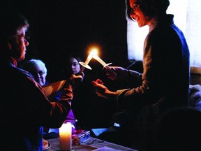 Sister Shirley Morris and Cate Henderson, gardener and seed saver for Heirloom Seed Sanctuary, perform a candlelit ritual for the Winter Solstice in 2011. This year’s blessing of light ceremony will be held Dec. 20 at 3:30 p.m.    Contributed photo