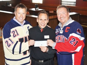 Wetaskiwin-Camrose Sign of Hope campaign chairman Dave Dowler, middle, together with Wetaskiwin Icemen director Glen Rogers, left, and president Rob Dyck, accept a $5,000 cheque from Boston Pizza. It’s the second such cheque Boston Pizza donated this year to the Sign of Hope campaign
