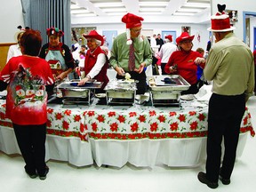 Kingston Y Service Club volunteers Doug Boyd, Anne Dickson, Ruth Hughes, Norma Levesque, Vanda Lynch, Beverly Robinson and Gerrie Dickson served up dinner for over 300 people during  the Salvation Army Rideau Heights traditional Christmas feast at the Rideau Heights Community Church on Dec. 15.