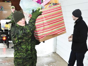 RYAN PAULSEN    Cpl. Heather Wilson hauls a box full of Christmas cheer into the Petawawa Legion as the 25th annual 2 Service Battalion Trucker Toy Drive entered its final phase on Monday morning. Once brought into the Petawawa Legion, the toys are sorted and given out to needy families in the community.