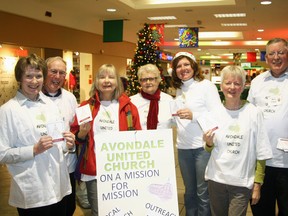 Members of Avondale United Church were on a mission for mission Monday evening at Tillsonburg’s Town Centre Mall, passing out invitations to their candlelight Christmas Eve service. The casual dress ‘come-as-you-are’ service is scheduled to being at 7 p.m. and is open to all. Pictured here, from left, are: Diane Burgess, Larry Donnelly, Susan Barker-James, Laura Hawley, Tamara Bull, Carol Hagle and Rev. Fred Hagle. Jeff Tribe/Tillsonburg News