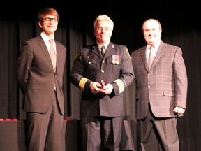 an Hefkey (left) and Rick Hamilton present medal to Fire Chief Paul Officer with the Queen’s Diamond Jubilee Medal. He was one of 55 recipients to get the medal.
Photo by DAVID BRIGGS/FOR THE STANDARD