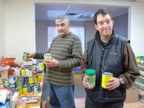 Harold Carter from Iron Bridge and Ivan B. Johnson from Blind River assist with the food sorting for the Blind River Christmas Basket Project.
Photo by SERGE ALLAIRE/FOR THE STANDARD