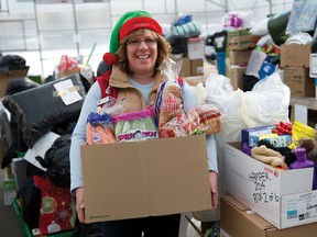 Airdrie Lioness president Crystal Adamo stands near some of the Christmas Hampers ready for delivery on Sunday. 
JAMES EMERY/AIRDRIE ECHO