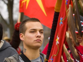 Alex Rogers of Sarnia holds an eagle staff at the rally held in Ivey Park at the forks of the Thames Wednesday. Adams, and hundreds of native Canadians walked from the 401 to the downtown Wednesday as part of the Idle No More protest against the Harper government's treatment of native issues. MIKE HENSEN/QMI AGENCY