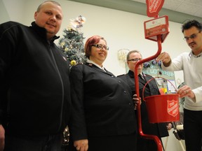 Mayor Bill Given, right, makes the first donation to officially kick off the Salvation Army's Christmas kettle campaign in mid November at the Family Service Centre on 102 Street. He is joined by coordinator Kerry Harris, left, Maj Glenda Roode, middle, and Maj. Daniel Roode. The campaign is behind last year’s pace by about $16,000 with just a week left to go.

ADAM JACKSON/DAILY HERALD-TRIBUNE/QMI AGENCY