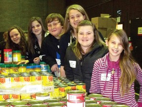 Grade 7 students from St. Anne's School hand out tuna, beans, jam and peanut butter to fill the holiday hampers. Pictured are Madison Aitkens, Alexis Roy, Leaghm Kirkay, Amanda Williamson, Alyssa Anderson and Katie Hamil. 
Staff photo/KATHRYN BURNHAM
