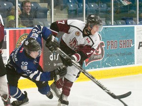 London Nationals forward Matt Wildman, left, drops to the ice after battling for the puck with Chatham Maroons forward Trevor Richardson during Wednesday's game at the Western Fair Sports Centre in London. The Nationals won 4-3 in overtime.
CRAIG GLOVER The London Free Press / QMI AGENCY