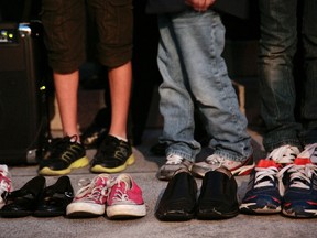 Shoes representing lost lives as people gather for an interfaith candlelight prayer vigil to end gun violence in front of Los Angeles City Hall in Los Angeles, California December 19, 2012. A gunman killed 20 children and six adults in a shooting rampage at Sandy Hook Elementary School in Newtown, Connecticut on December 14. (REUTERS/Jason Redmond)