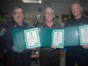 St. Thomas Police Service Const. John Burgess, left, special Const. Mike Rogozynski and Const. Cam Constable during a celebration at police headquarters Wednesday in honour of their retirement. The three are holding certificates from the city recognizing their service to the community.