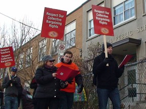Teachers walk a picket line in front of Central Public School Thursday morning as part of a series of province-wide rotating strikes.