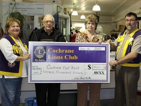 Bernie Brydle (far left) and Daniel Touchette (far right) from the Cochrane Lions Club presented Ray Fortier, Treasurer of the Cochrane Food Bank and Darlene Sayers, Food Bank President with $15,000 on December 13.