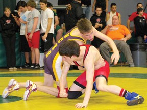 Wetaskiwin Sabre Nakai McDonnell lunges for his opponent during the Lethbridge Collegiate Institute Green and Gold Classic Dec. 15. The local wrestler was one of six to medal at the meet.