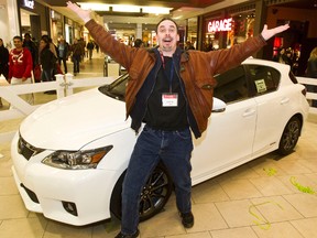 Lexus winner Dave Waggoner gets excited by his new car at Kingsway Mall in Edmonton, Alta. on Wednesday, Dec. 19, 2012. Codie McLachlan/Edmonton Sun