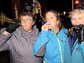 Ringing in the New Year at the Tillsonburg Clock Tower in 2011/2012 are, from left, Carol Honsberger, Kathleen Robinson, and Elaine Schmidt. The Rotary Club of Tillsonburg will not be hosting a clock tower/fireworks celebration this year. File Photo by CHRIS ABBOTT/TILLSONBURG NEWS/QMI AGENCY