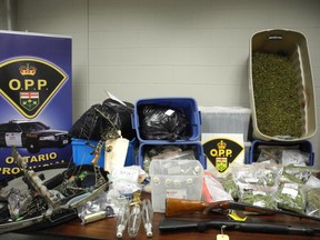 Police seized $88,000 worth of marijuana, two long guns, a crossbow, a compound bow, cash and growing equipment from an operation west of Simcoe. (OPP Photo)