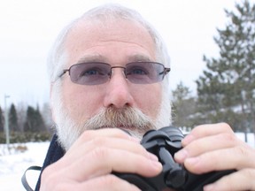 Mark Joron looks through his binoculars during the a past Christmas Bird Count in Timmins. The 2013 edition of the bird count takes place on Dec. 21.