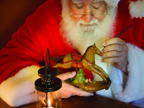 Santa Claus hard at work on one of the thousands of creations he’ll be delivering to boys and girls around the world on Christmas Eve night.