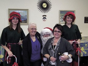 The Pioneer 73 Club held its annual Christmas dinner at the club on Friday, Dec. 14. Members and guests enjoyed their supper before Santa arrived to hand out some gifts.
Left: Santa and his elves with Carol Hart and Brenda Preece.
