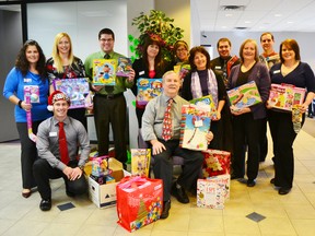 Pictured is Pastor Bob and his wife Debbie receiving the toys from the employees at Meridian Bank.