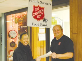 Pictured, Sullivan with Ed Giles of the Salvation Army Food Bank.