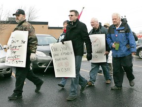Members of Brantford District Labour Council affiliates march on MP Phil McColeman's office on Tuesday, Dec. 11, 2012, to protest Bill C-377. (CHRISTOPHER SMITH/QMI Agency)