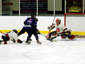 Gananoque Islanders goalie Riley Phillips stretches out to defend the net as two Picton Kings players crash in towards him during their game this past weekend.