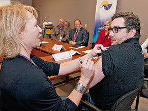 BRIAN THOMPSON, The Expositor

Marg McMahon, manager of organizational health at Brantford General Hospital, gives a flu shot to Brantford Mayor Chris Friel during a news conference on Thursday. Health-care officials are urging people to get flu shots.