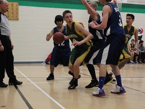 The senior boys' MUCC Comets Justin Neher works his way out from being surrounded by players from the Kinistino Blues on Thursday night.