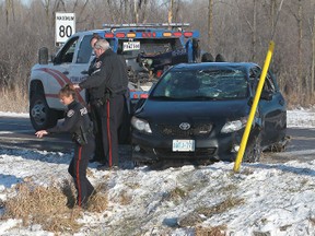 Ottawa police investigate a serious accident at the corner of Upper Dwyer Hill Road and March Road in Ottawa, Ont. Thursday Dec 20, 2012. Susan Martinat of Petawawa was air lifted to hospital without vital signs after her car was found upside down in a ditch filled with water.
