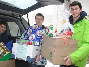 A Grade 10 French immersion civics class at Timmins High organized a school-wide effort to collect gifts and food for local families in need. The school adopted seven families and fulfilled the Christmas wishes of the children in those families. Among the Civics class students were Ryan Giguere, from left, Christian Smith, and Brody Forget.