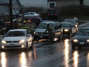 RAIN, SLEET AND SNOW
County of Brant OPP officers and firefighters went to a collision scene on Dundas Street West near Arnold Street in Paris, Ontario the evening of Thursday, Dec. 20, 2012. No one appeared to be hurt, but a spill had to be cleaned up by the firefighters. Wet and slick conditions caused by a mix of freezing rain, snow and rain made driving treacherous throughout the evening. More snow - albeit flurries - is forecasted for late Friday and on Saturday.  MICHAEL PEELING/THE PARIS STAR/QMI AGENCY