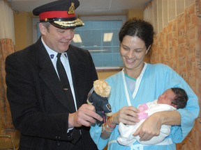 Chief Bob Davies visits with Courtney Pine and her daughter, Samantha, at Sault Area Hospital on Friday, Dec. 21, 2012.