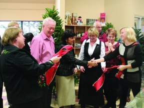 County Clothes-Line store manager Shelley Roth shakes hands with Strathcona County Mayor Linda Osinchuk during the ribbon-cutting for the store’s new location on Athabascan Avenue in Sherwood Park on Thursday, Dec. 13. Trent Wilkie/Sherwood Park News/QMI Agency