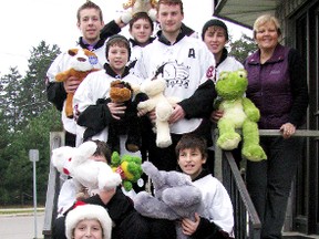 Members of the Kent Cobra 'AA' Minor Bantam team drop off stuffed animals to the Foundation of Chatham-Kent Health Alliance. These are some of the stuffed animals collected during a teddy bear toss held during team's Nov. 25, 2012, game against the Southpoint Capitals at the Tilbury Arena. (Contributed photo)
