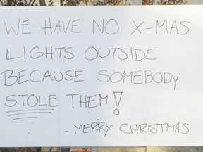Chalene Weir put up this sign after someone stole the Christmas lights that adorned the front door of her Cherry Street house earlier this week.
Hilary Thomson for The Whig-Standard