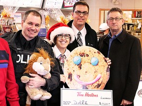 The DARE (Drug Abuse Resistance Education) program accepted a $19,600 donation from area Tim Hortons on Thursday raised during the Smile Cookie Campaign. The donation will ensure further expansions in the DARE program. From left to right: TPS Const. Rick Lemieux, Linda Venneri, Rob Knox and OPP Const. Paul Harrison.