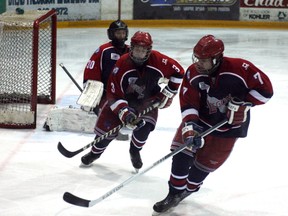 Kirkland Lake Legion 87's Jordan Wilson (number 7) and Zach Joron (number 3) hunt down the puck during Saturday's 6-1 loss to the New Liskeard Cubs.