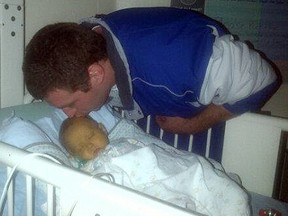 Rob Ficht of Sarnia plants a kiss on his seven-month-old nephew, Jaden Ficht, at Sick Kids Hospital in Toronto, the night before they each underwent serious surgery. Rob donated part of his liver to the baby boy, in order to save his life. SUBMITTED PHOTO/FOR THE OBSERVER/QMI AGENCY