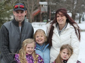 The Alguire family of dad Patrick, left, mom Crystal, and daughters Kaleigh, left, 7, Kirstyn, 10, and Kiarah, 5, have been living in shelters and motels since losing their home to a massive fire. The family had just recently moved from Kingston to Sarnia, but are now back with their families in Kingston with only a couple of outfits each, and their dog, Maya. 
Tori Stafford/Whig-Standard
