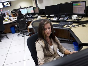 Ian Kucerak/QMI Agency
Shayla Fisher, a telecommunications operator, answers calls at the RCMP ‘K’ Division Operational Communications Centre in Edmonton. Two centres in Alberta, one in Edmonton and one in Red Deer, are projected to handle 240,000 911 calls this year.