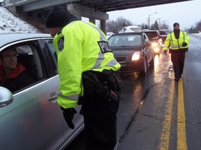 Officers chat with drivers at a RIDE program checkpoint. (QMI Agency file photo)