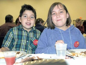 Jake Fournier, 8, and Rachel Fournier, 11, waste no time getting through their roast beef dinners at To Stratford With Love Saturday night. The food was “delicious” and “awesome”, they said.