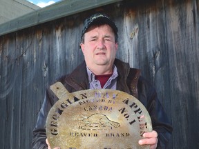 Bill Vail of Meaford with a brass apple barrel lid stencil and a rare Indian Head apple box he intends to donate to Grey Roots Museum and Archives along with $10,000 in seed money to help them set up an apple growing historical display.