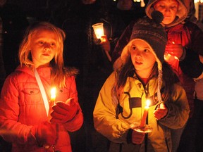 Maia Parker (left), 10, and Mackenzie Deane, nine, both of Delhi, took part in a candle light vigil in front of the Delhi Public School on Sunday night. The event was held to help local residents grieve the school shooting in Newtown, Connecticut, earlier this month. (DANIEL R. PEARCE Simcoe Reformer)