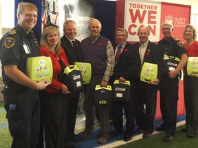 Bradley Nuttley of Stormont Dundas and Glengarry Emergency Medical Services, Cindy Rowe of the Heart and Stroke Foundation, SDSG MPP Jim McDonell, Cornwall Mayor Bob Kilger, SDSG MP Guy Lauzon, South Glengarry Mayor Ian McLeod, Myles Cassidy and Micheline Turnau of the Heart and Stroke Foundation pose with defibrillators at the Benson Centre. McLeod and S,D and G colleagues voted recently to ask the province to place more defibrillators in privately-owned facilities.
