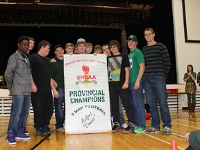 The graduating members of the SHSAA 9 Man football champion Melfort Comets pose with the team’s championship banner, the team was presented with the banner at a special pep rally on Friday, December 21.
