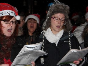 Carollers sing outside Reanna Pyne's home in Sarnia, Ont. Monday, Dec. 24, 2012. The event was organized on Facebook after several Christmas decorations belonging to the terminally ill teen were destroyed by vandals. (BARBARA SIMPSON, The Observer)
